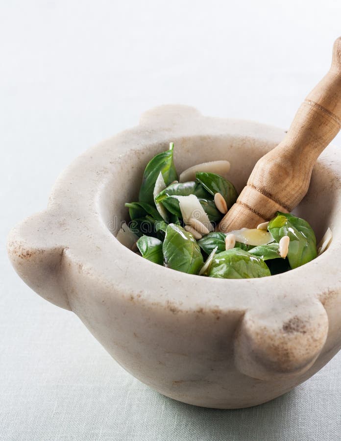 Making pesto with a mortar stock image. Image of olive 26046027