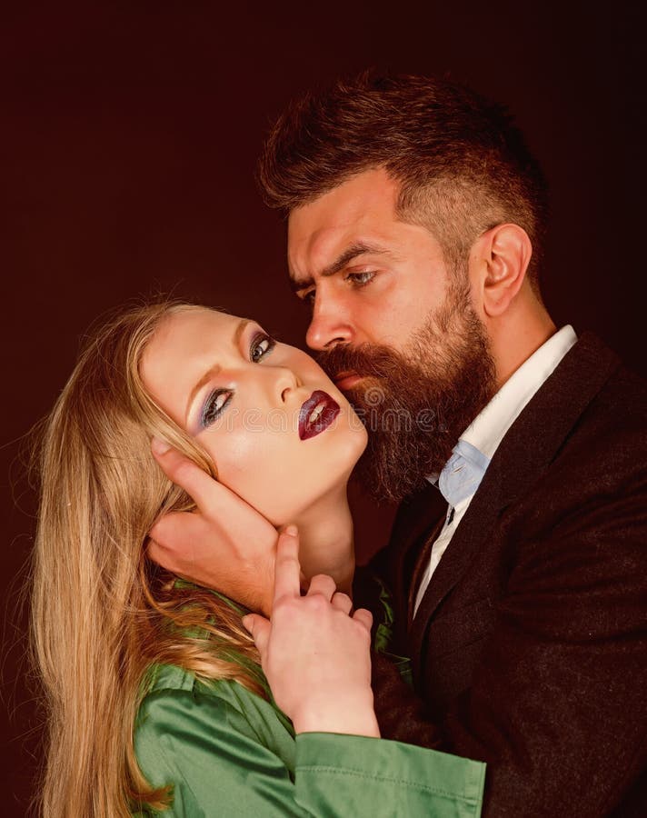 Making the relations exclusive. Bearded man hug woman with long hair. Couple in love. Style icons. Intimate couple in stock photography Making the relations exclusive. Bearded man hug woman with long hair. Couple in love. Style icons. Intimate couple in stock photography