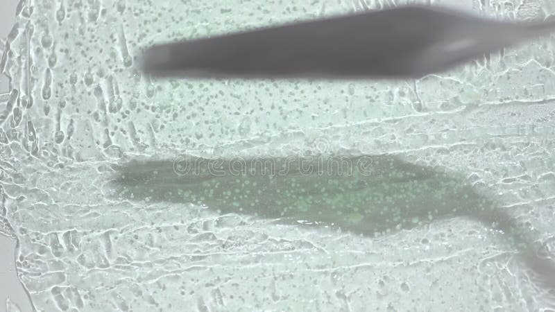 Making strokes on transparent gel smear with metal spatula