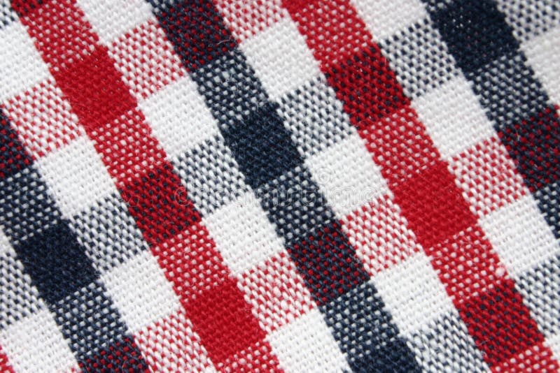 Closeup of colorful checked cotton fabric texture, the colors are white, red and navy blue. Closeup of colorful checked cotton fabric texture, the colors are white, red and navy blue