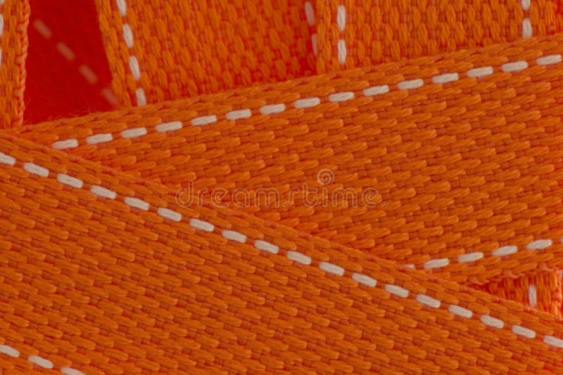 Makronahaufnahme des orange Tragriemens als Hintergrund stockfotografie Makronahaufnahme des orange Tragriemens als Hintergrund stockfotografie