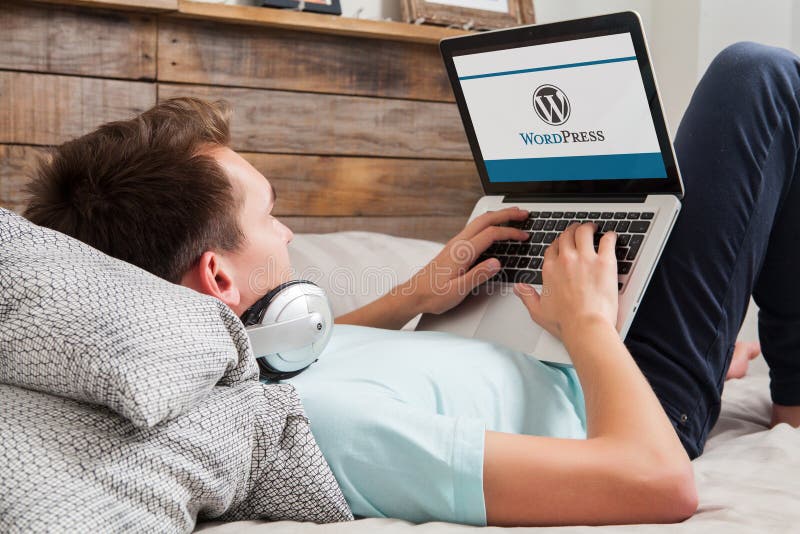 MALAGA, SPAIN - NOVEMBER 10, 2015: Wordpress brand logo on computer screen. Man typing on the keyboard. Web designer using Wordpress CMS to develope a website MALAGA, SPAIN - NOVEMBER 10, 2015: Wordpress brand logo on computer screen. Man typing on the keyboard. Web designer using Wordpress CMS to develope a website