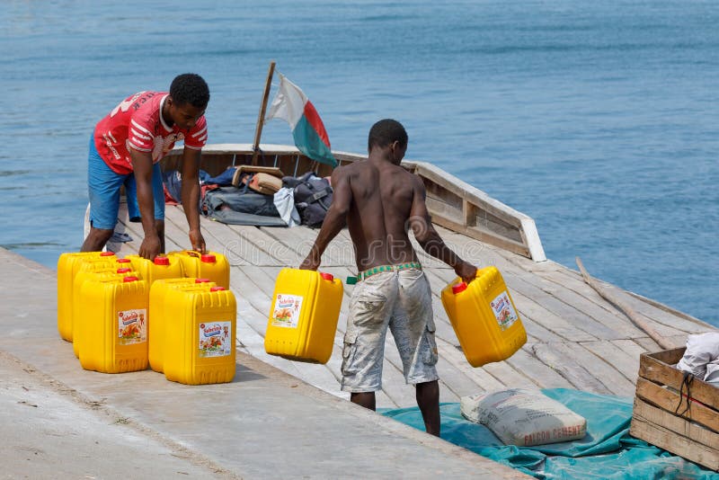 Malagasy men transport cargo from ship in port of Nosy Be, Madagascar royalty free stock images Malagasy men transport cargo from ship in port of Nosy Be, Madagascar royalty free stock images