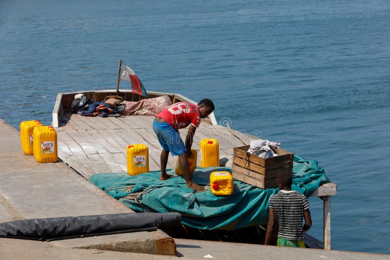 Malagasy men transport cargo from ship in port of Nosy Be, Madagascar royalty free stock image Malagasy men transport cargo from ship in port of Nosy Be, Madagascar royalty free stock image