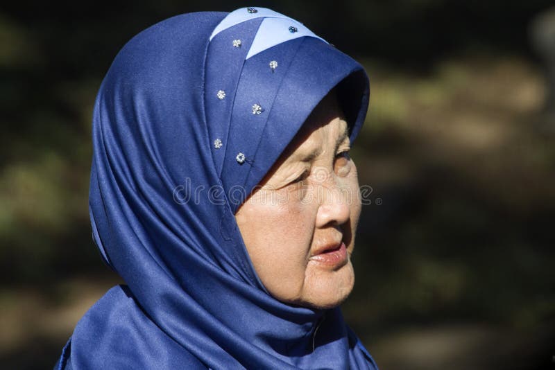 Indonesian woman with a blue headscarf stock image Indonesian woman with a blue headscarf stock image