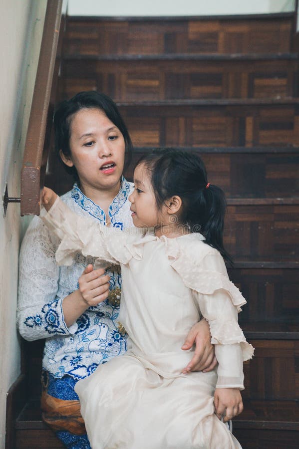 A malay m struggling to take a decent Aidilfitri picture with her kids stock photo. A malay m struggling to take a decent Aidilfitri picture with her kids stock photo