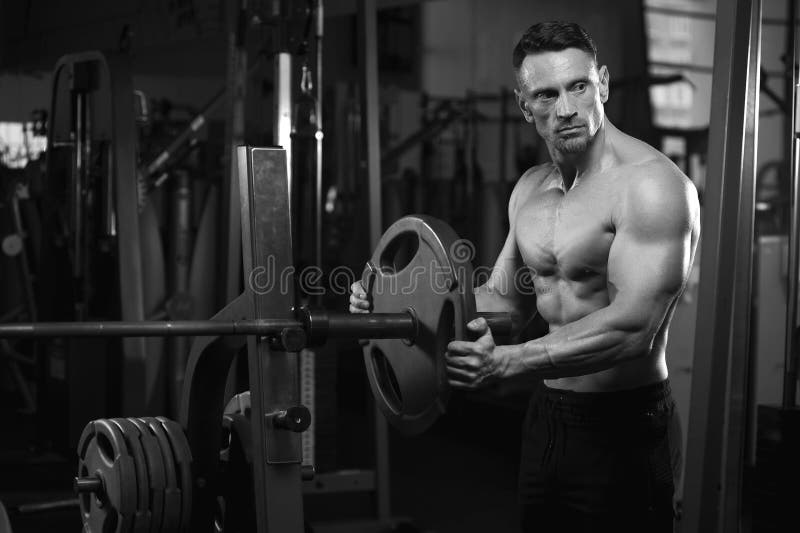 Male adult bodybuilder working out with weight