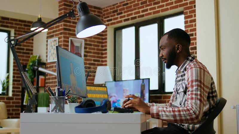 Male african american designer works with photo editing software stock photography