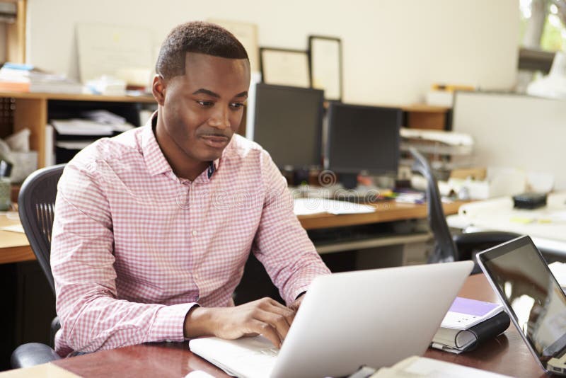 Male Architect Working At Desk On Laptop stock photos