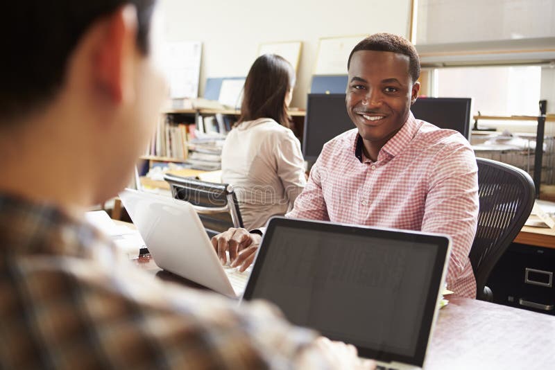 Male Architect Working At Desk On Laptop royalty free stock images