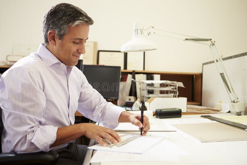 Male Architect Working At Desk In Office stock photography