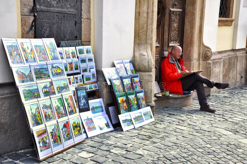 Male artist sales his paintings on the streets.Many street artists draw and sell paintings on street.Szentendre,Budapest