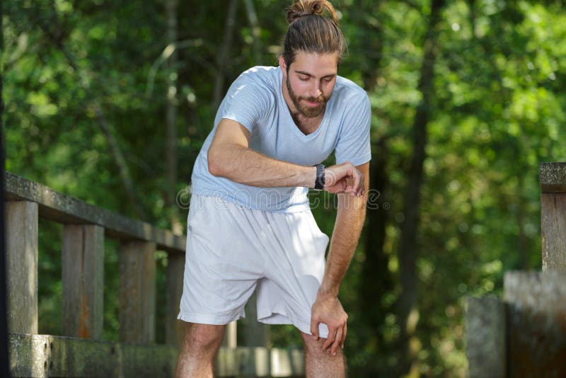 Male athlete checking results on smart watch royalty free stock photography