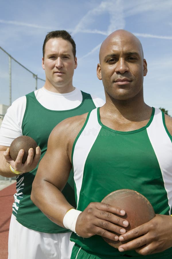Male Athletes Holding Shot Put And Discus