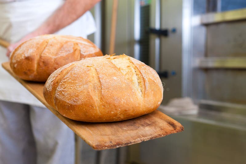 Male baker baking bread stock images