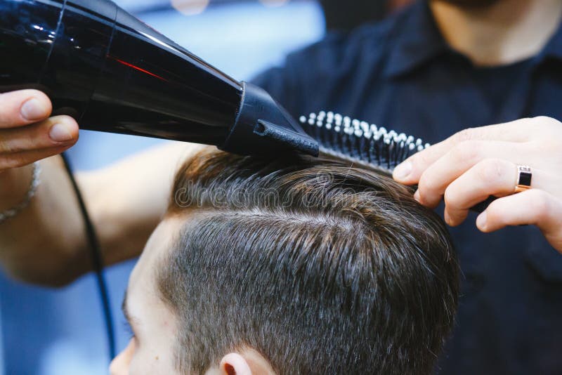 Male Barber Makes Hair Styling of a Young Man Using a Dryer Stock Image -  Image of care, beard: 127725357