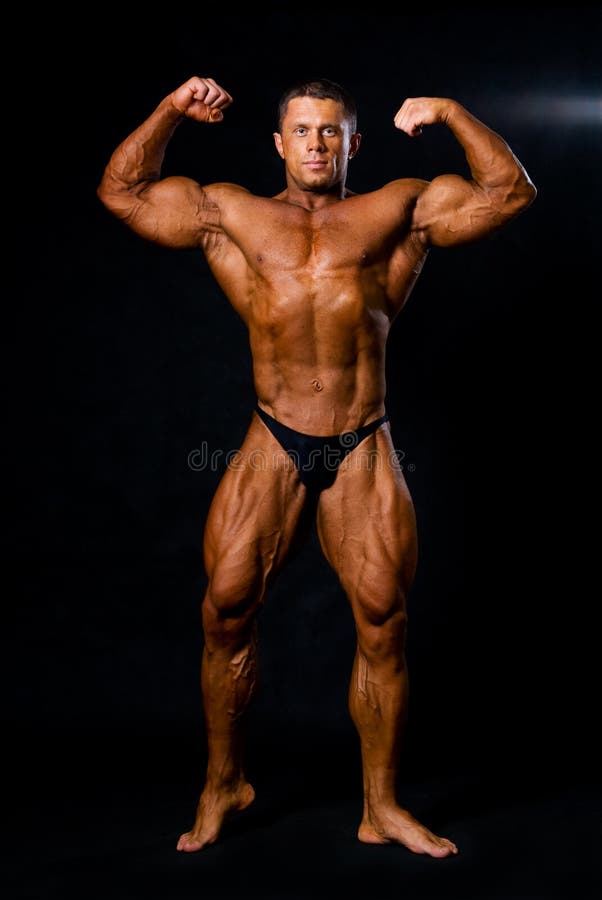 A male bodybuilder flexing his muscles. stock photography
