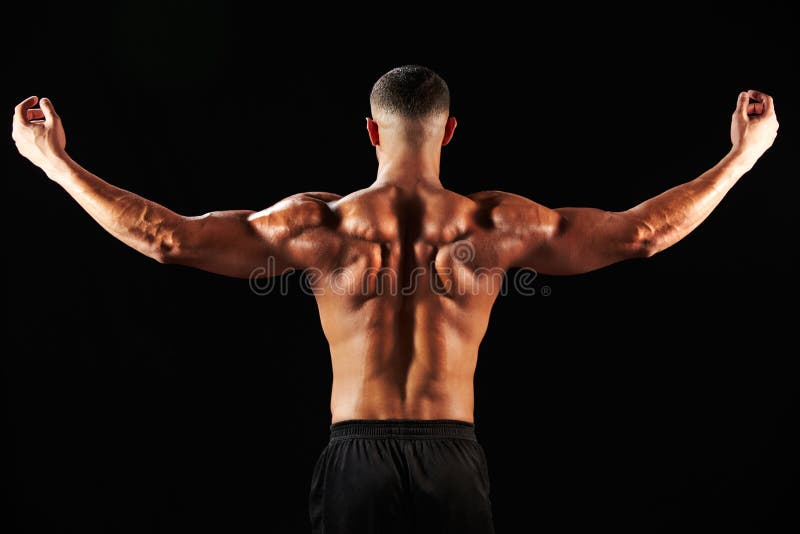 Male bodybuilder flexing muscles, back view