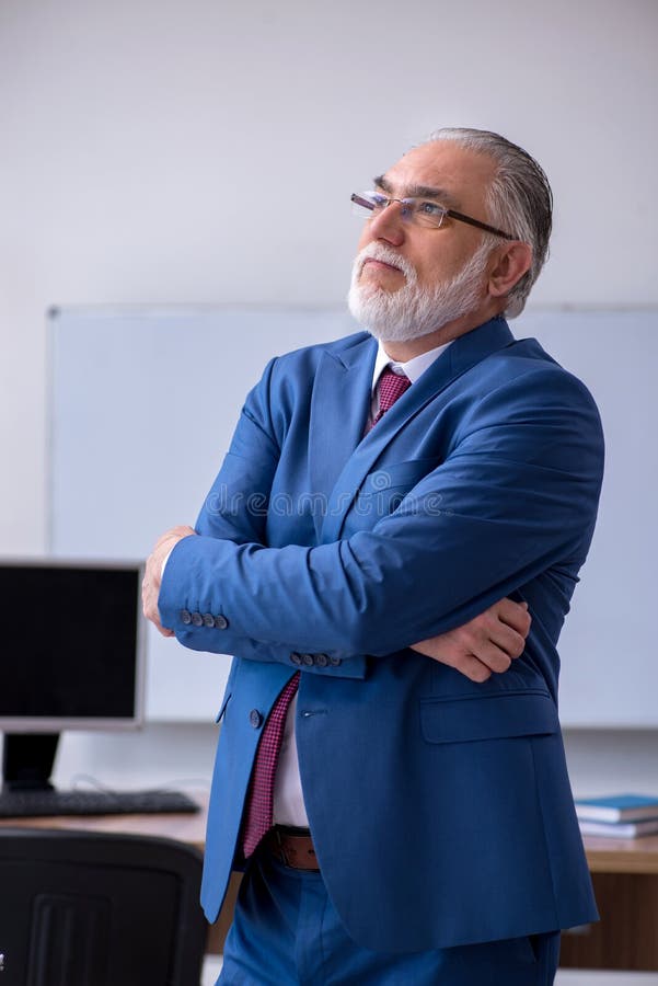 Old male boss employee working in the office royalty free stock photo
