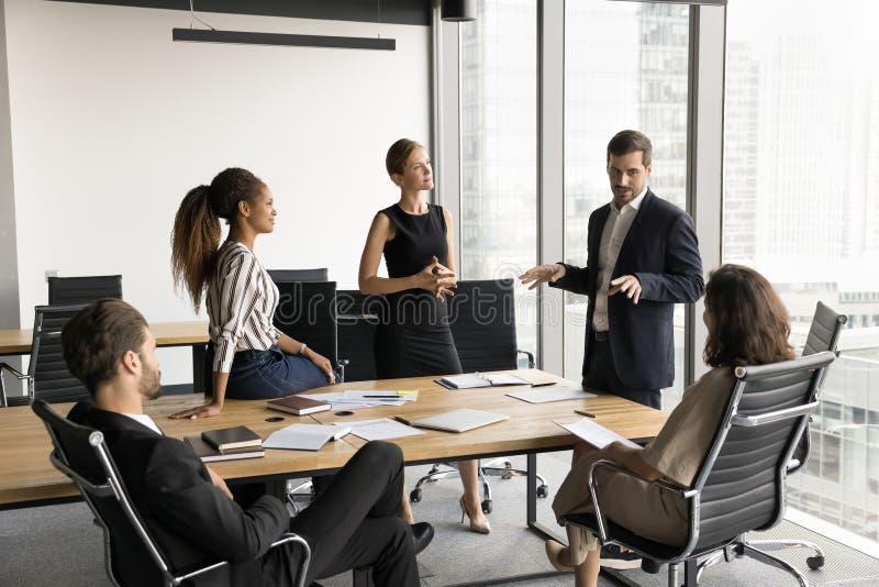 Male boss leading conversation, presenting ideas, share strategy during briefing royalty free stock photos