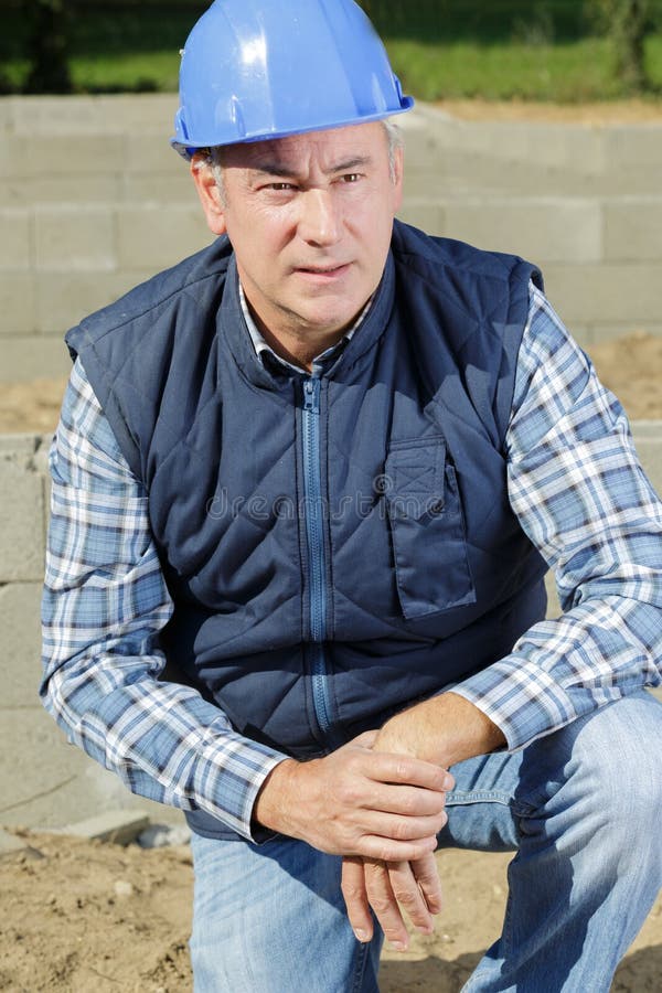 Male builder looks at construction house royalty free stock photography Male builder looks at construction house royalty free stock photography