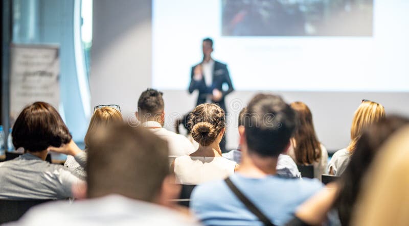 Male business speaker giving a talk at business conference event.