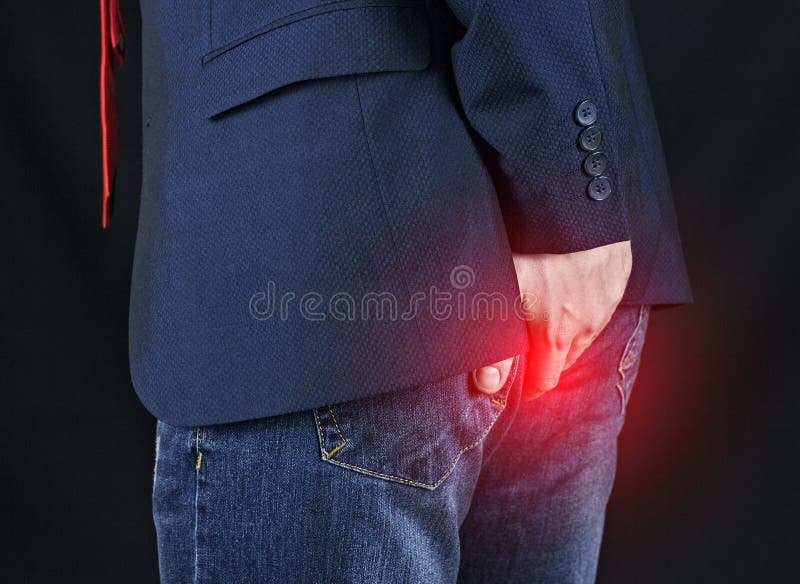 Male businessman holding his ass, hemorrhoids stock photography