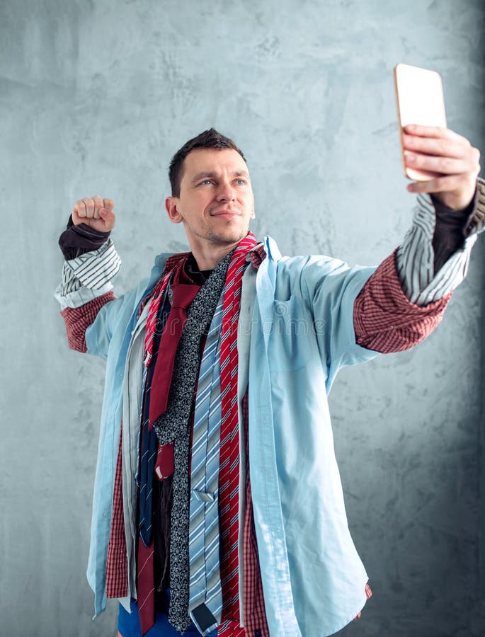 Male buyer makes selfie at clothing store