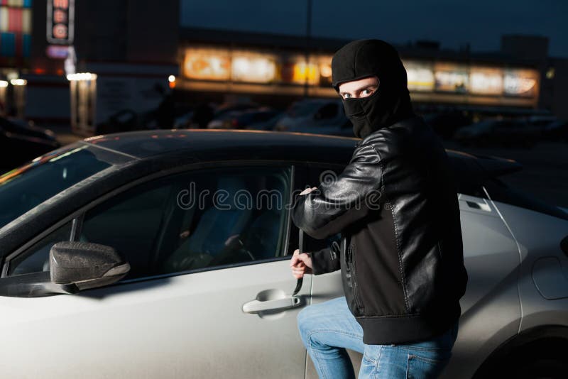 Male car thief open door with jemmy stock images Male car thief open door with jemmy stock images