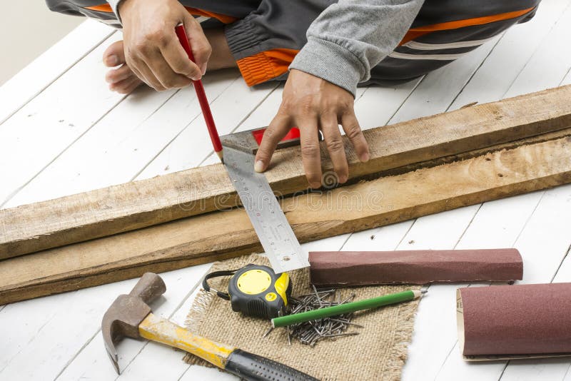 Male carpenter working with wood pencil and tools at work place. Background craftsman tool royalty free stock images Male carpenter working with wood pencil and tools at work place. Background craftsman tool royalty free stock images