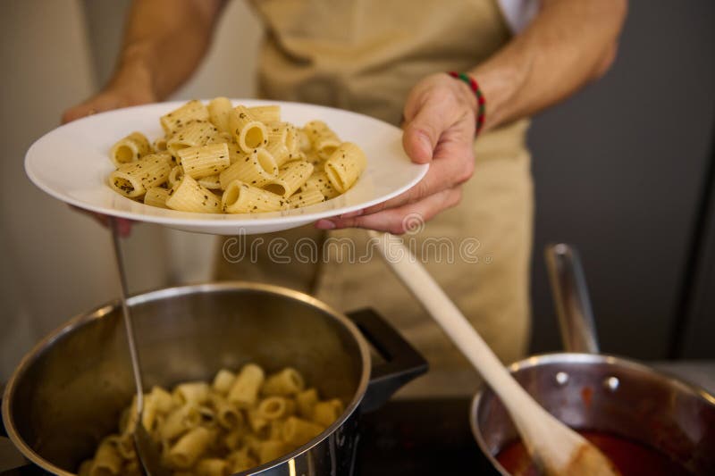 Male Chef Plating Up Italian Pasta before Serving for Customers. Close ...