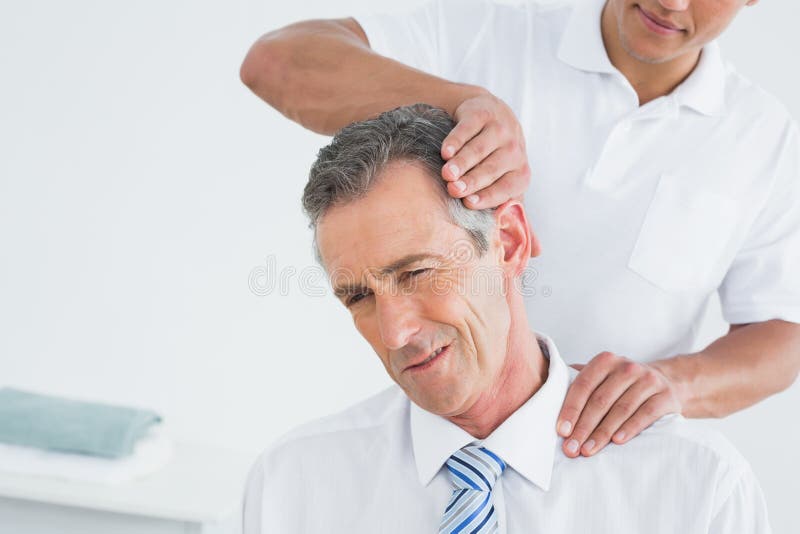 Male Chiropractor Doing Neck Adjustment Stock Image Image of wellness