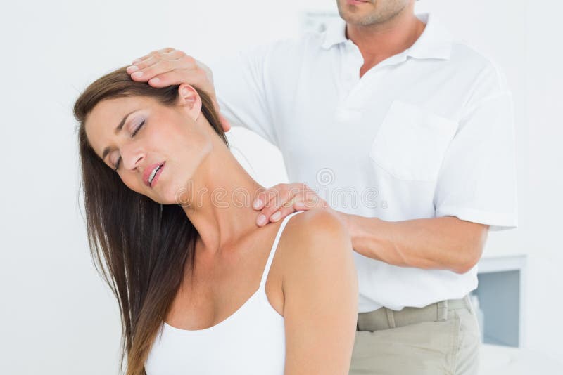Male Chiropractor Doing Neck Adjustment Stock Image Image of sitting