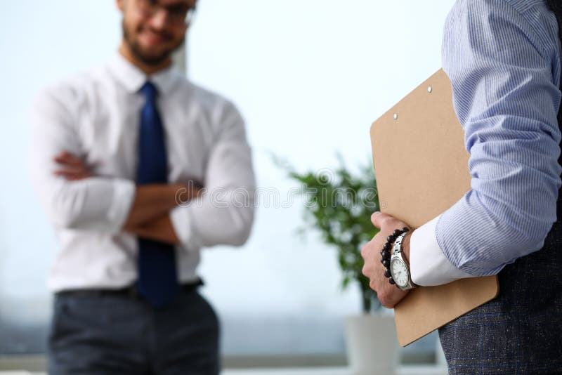 Male clerk arm in suit and tie with paper clipped to pad royalty free stock photography Male clerk arm in suit and tie with paper clipped to pad royalty free stock photography