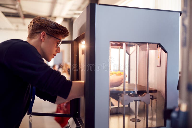 Male College Student Studying Engineering Using 3D Printing Machine