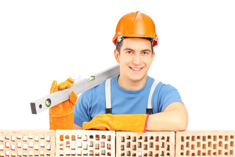 Male construction worker holding a bubble level and resting on a royalty free stock photography