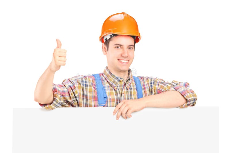 Male construction worker posing behind a panel stock photos