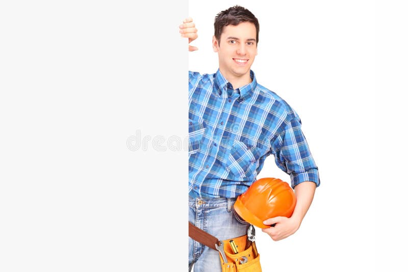 Male construction worker standing behind blank panel royalty free stock photo