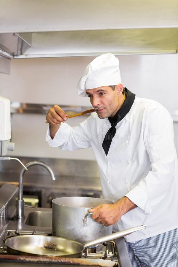 Male Cook Tasting Food in Kitchen Stock Image - Image of male, adult ...