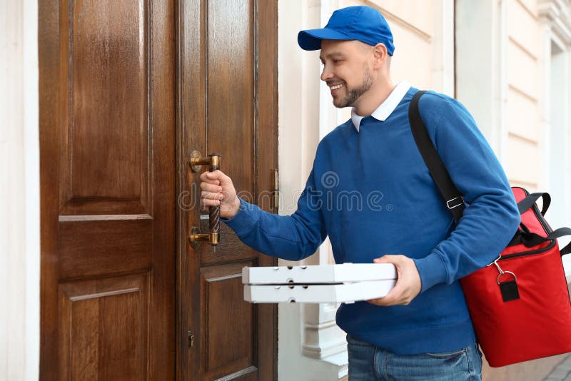 Male courier with order at entrance royalty free stock images Male courier with order at entrance royalty free stock images