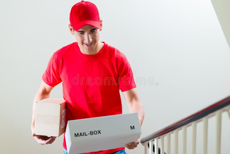 Male Courier in Uniform Looking at Mail Boxes Stock Photo Image of
