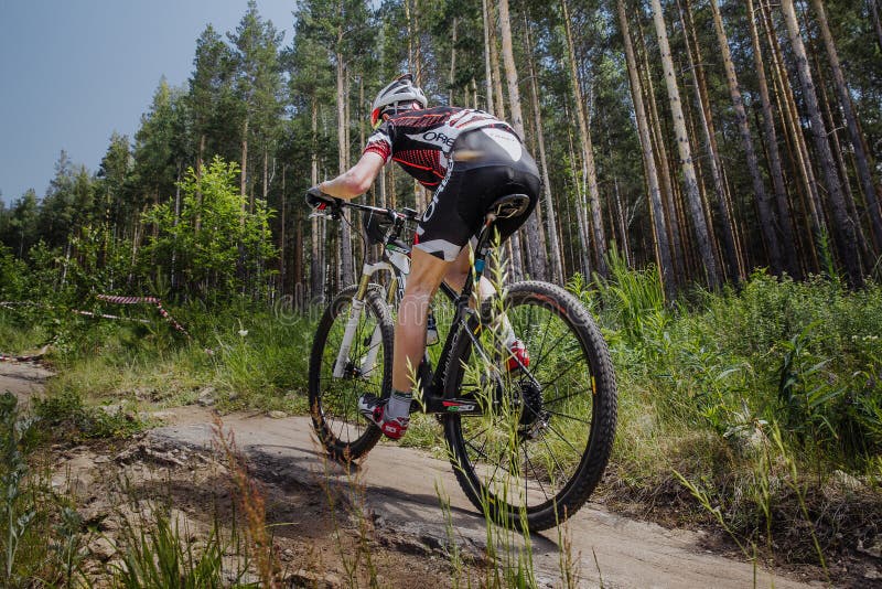 Male cyclist riding a bike on forest trail royalty free stock photography Male cyclist riding a bike on forest trail royalty free stock photography