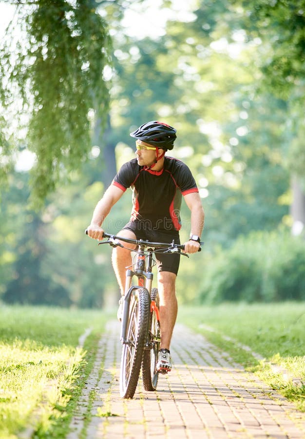Male cyclist training in green park royalty free stock photo Male cyclist training in green park royalty free stock photo