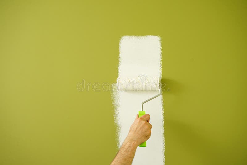 Male Decorator Painting Wall with Roller Indoors, Painting Work Stock