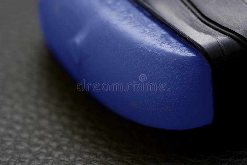 Closeup of a blue deodorant stick for men, isolated on black leather background. Closeup of a blue deodorant stick for men, isolated on black leather background.