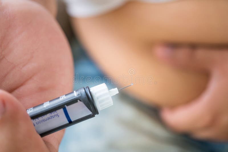 Male diabetes patient holding syringe for insulin injection with