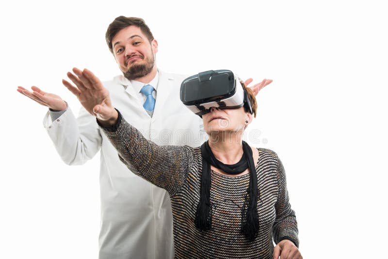 Male doctor and female senior patient with vr goggles gesturing royalty free stock photo Male doctor and female senior patient with vr goggles gesturing royalty free stock photo