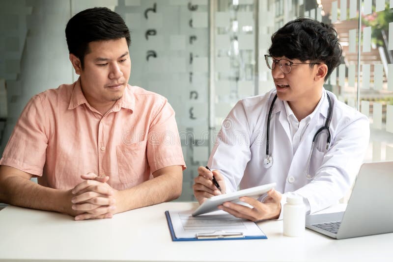Male doctor holding health check documents and explaining the results of the examination to the patient royalty free stock photos