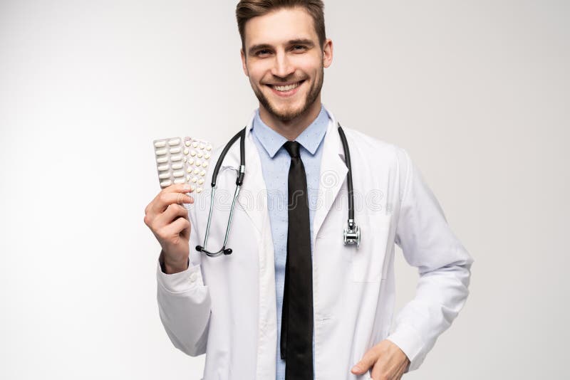 A male Doctor holding pill medical health care pharmacy concept. royalty free stock photo A male Doctor holding pill medical health care pharmacy concept. royalty free stock photo