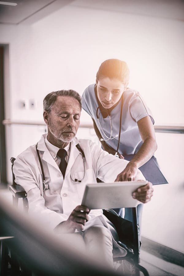 Male doctor with nurse talking over digital tablet royalty free stock image Male doctor with nurse talking over digital tablet royalty free stock image